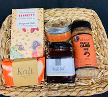 Load image into Gallery viewer, A gift basket with chocolate, soap, oil, salt and cajun rub