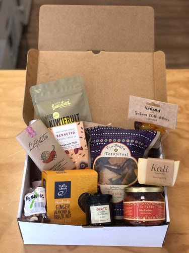 A gift box with chocolate, tortilla chips, salsa, nuts, biscotti and more.
