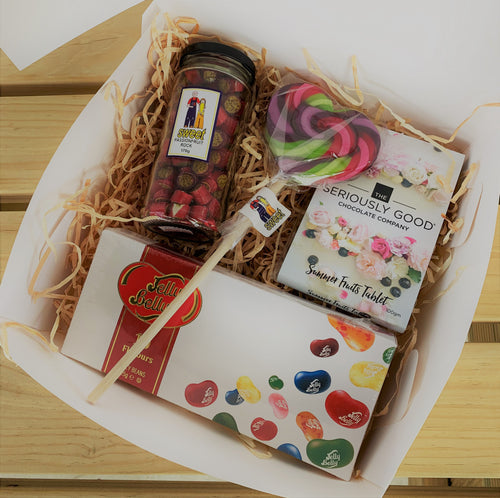 A gift box with chocolate, jelly bean, lollipop and sweets